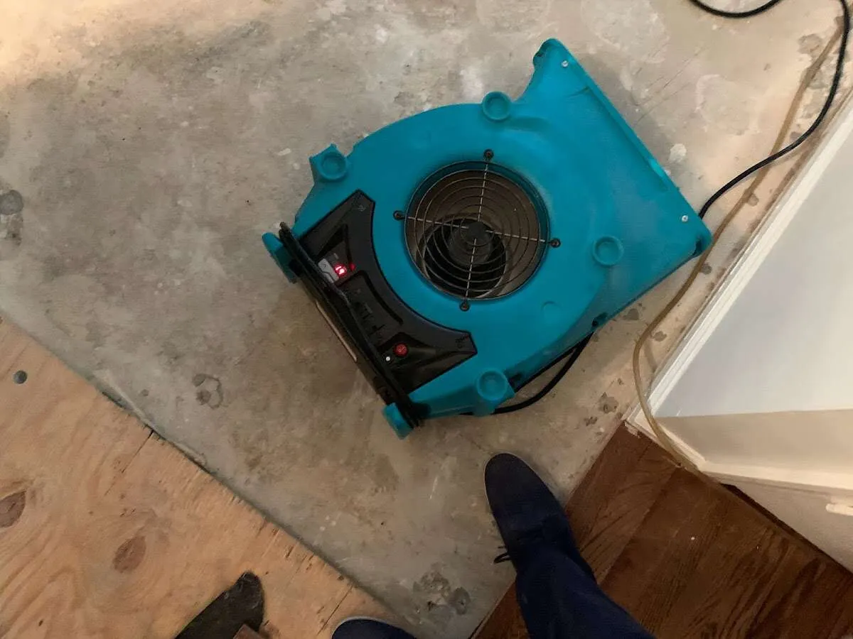 Air mover drying subfloor during Commercial Water Damage Restoration in Hueytown